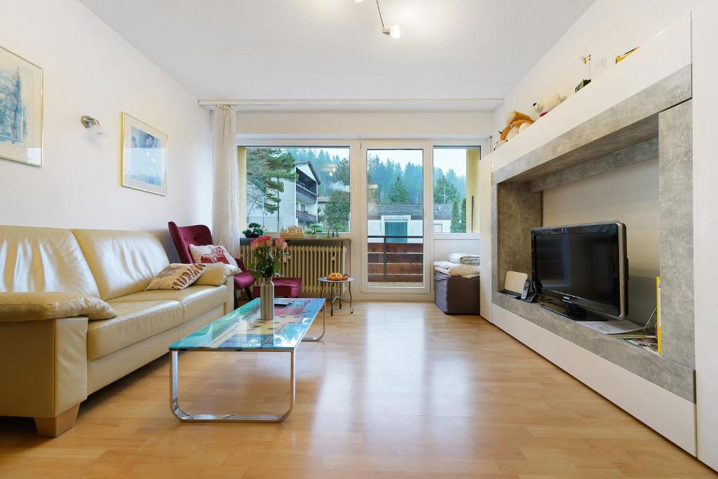 a living room with a couch and a fireplace at Ferienwohnung Dittmar am Kaffeehof in Bad Liebenzell