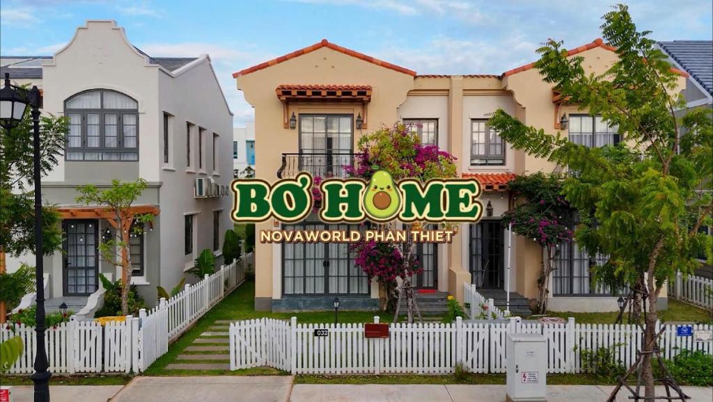 a house with a sign in front of it at Bơ Home Novaworld in Phan Thiet