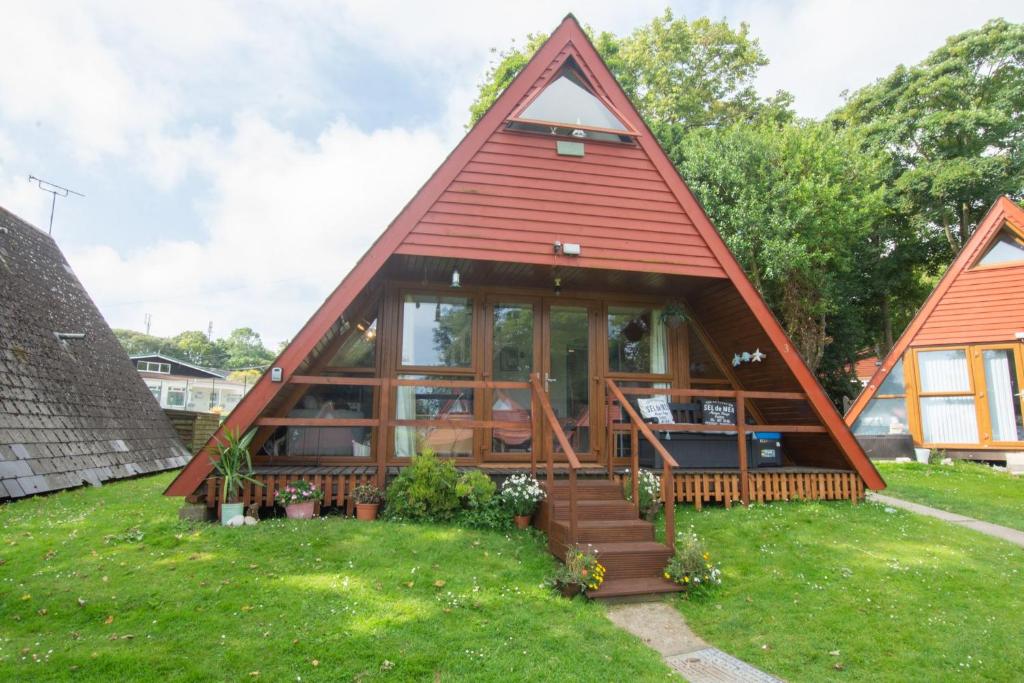 a small house with a red roof at Chalet Three in Deal