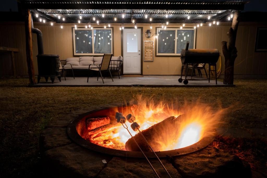 a fire pit in front of a house with lights at ArtLens Casa in Schertz