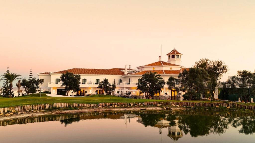 a view of a resort with a pond in front at Hotel Duquesa Golf Club in San Luis de Sabinillas