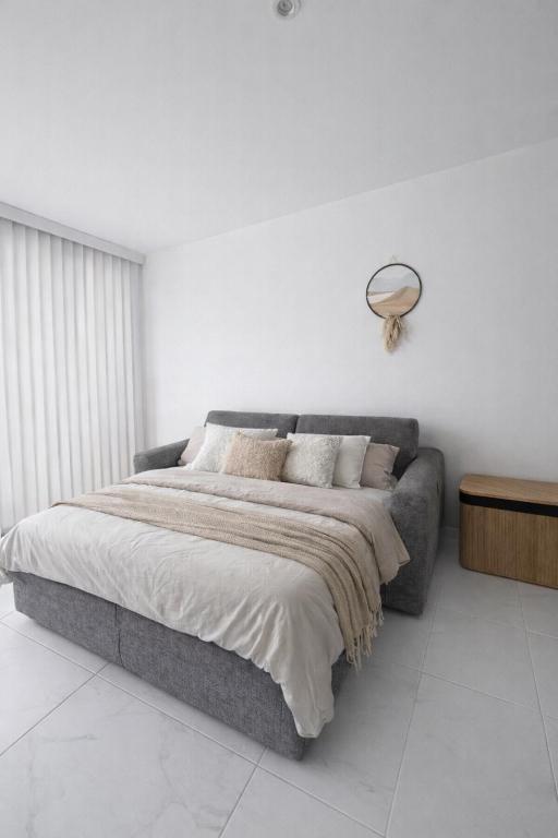 a bedroom with a large bed and a couch at Studio indépendant 22m2 in Massieux