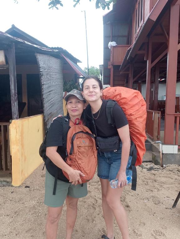 two women standing next to each other with a backpack at Naca Homestay in Manado