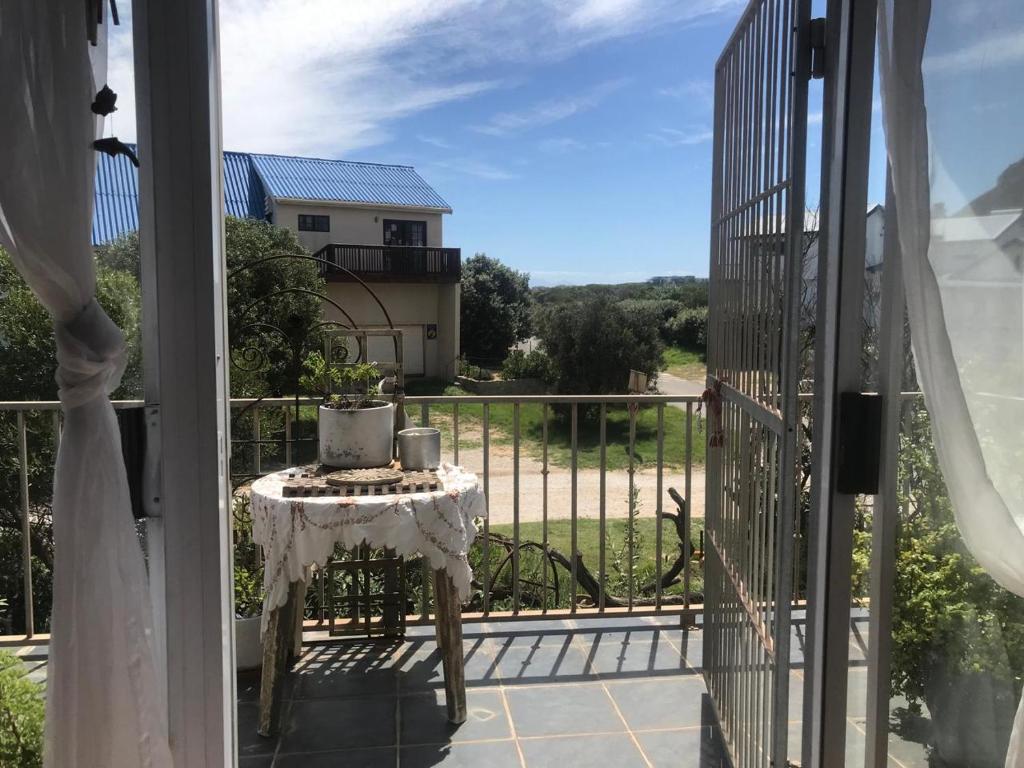 a table on the balcony of a house at 120 steps to the beach in Pringle Bay