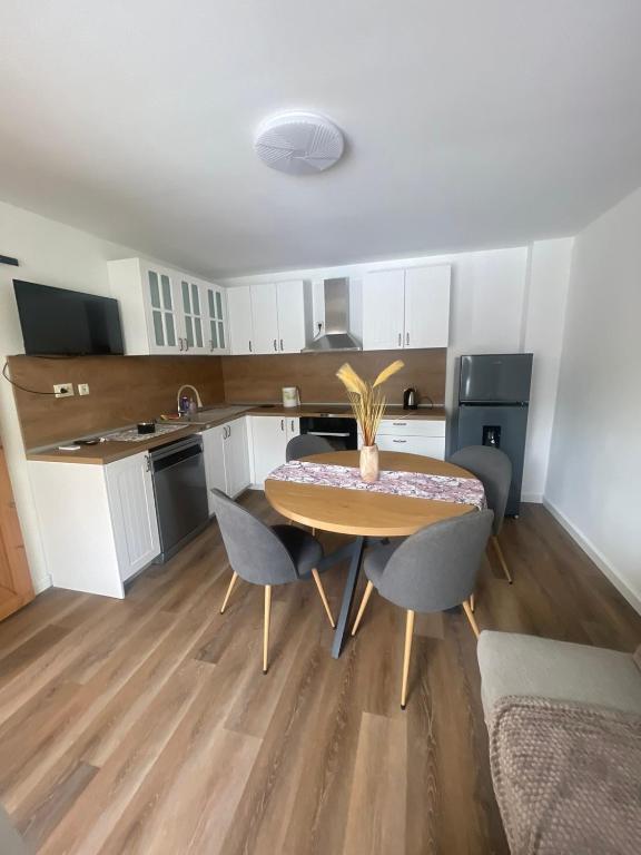 a kitchen and dining room with a table and chairs at Апартамент ФЕРДИНАНД in Ruse