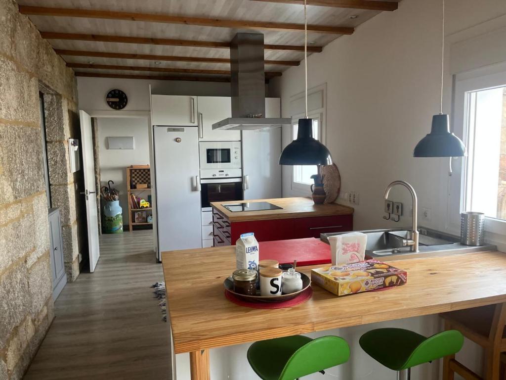 a kitchen with a wooden counter top in a room at Casa Bubela, O Castro de Dozón. in Dozón