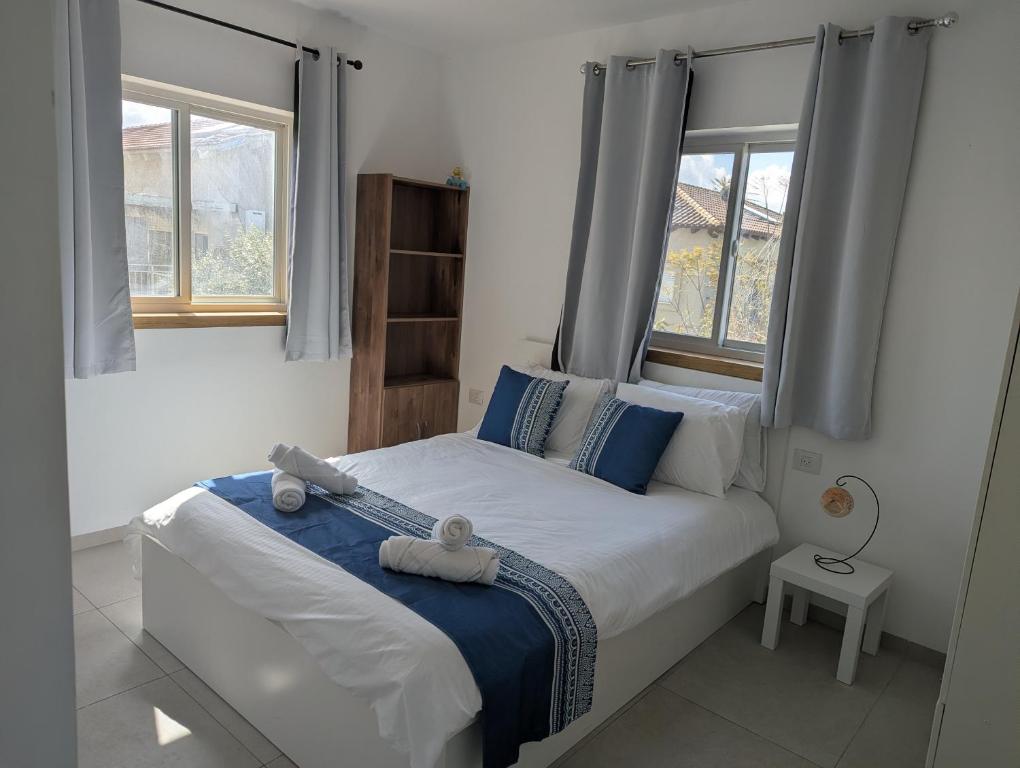 a bedroom with a bed with two stuffed animals on it at הבית הכחול in Haspin