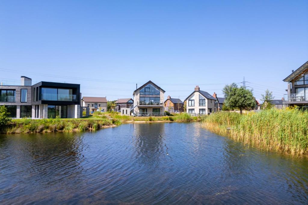a view of a river with houses in the background at Knighton in Warmwell