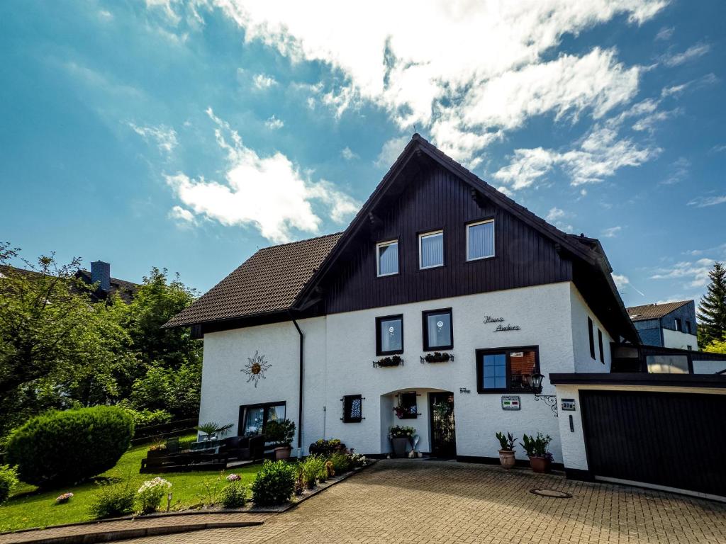 a large white house with a black roof at Ferienwohnungen Anders in Braunlage