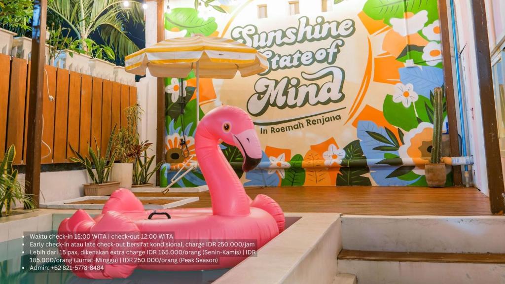 a pink inflatable pink flamingo in front of a restaurant at Roemah Renjana Sunny in Pampang