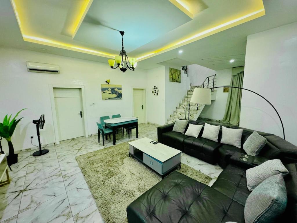 a living room with a couch and a table at The Cape - Apartment in Bamgbose