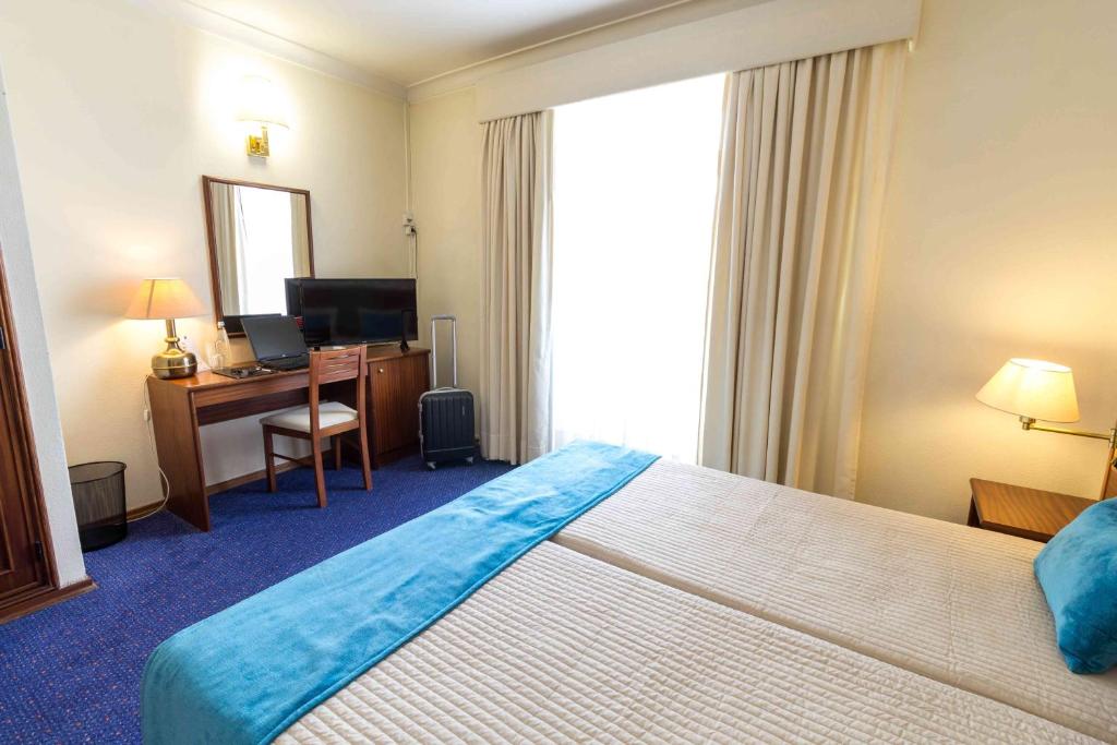 Uma cama ou camas num quarto em Hotel Eurosol Gouveia