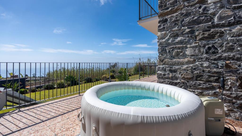 a hot tub on the side of a building at Casa da Felicidade by LovelyStay in Prazeres
