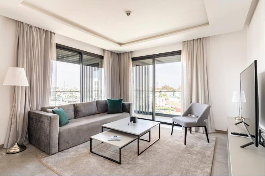 a living room with a couch and a chair at Makass Appart Hotel in Rabat