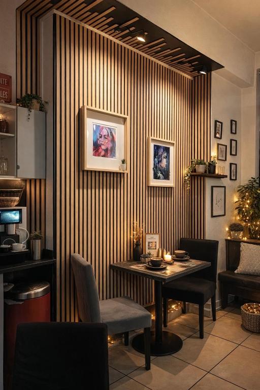 a dining room with a table and a striped wall at Vieille tour Hotel centre Rouen in Rouen