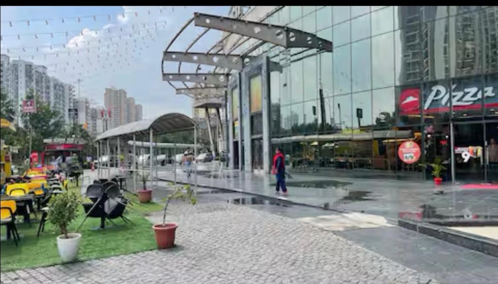 a person walking in the rain in a city at Rao Studio in Noida