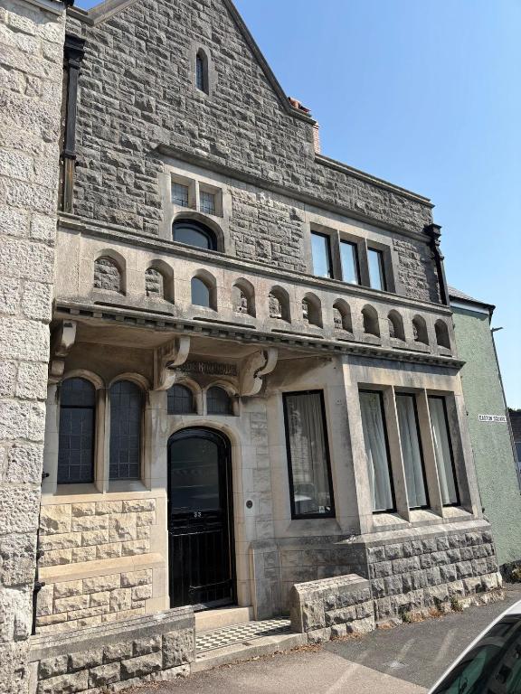 an old stone building with a door on a street at Nethercoombe House in Portland