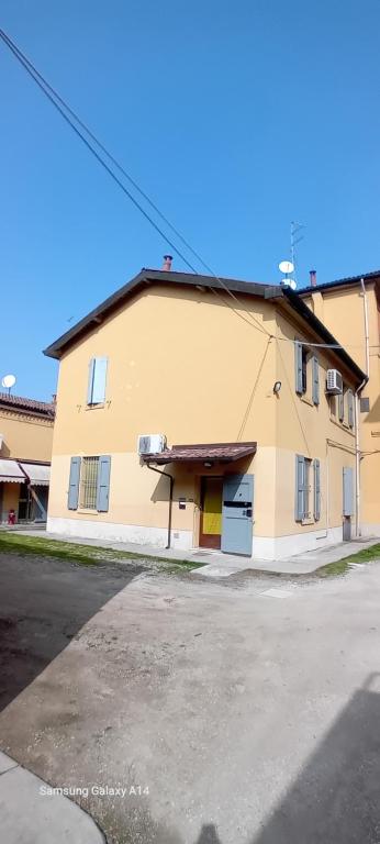 a large yellow building with a yellow door at Panigale90 in Bologna