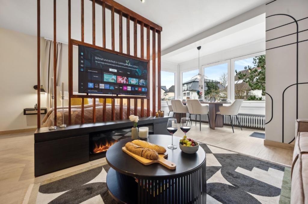 a living room with a fireplace and a tv at Modernes Design-Apartment am Drachenfels in Bad Honnef am Rhein