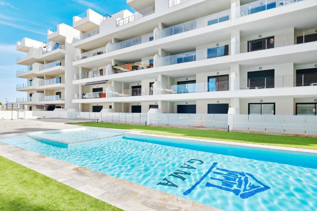 a swimming pool in front of a building at Velapi 23 in Roda