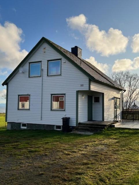 a white house sitting on top of a field at Tenant Farm House in Dverberg