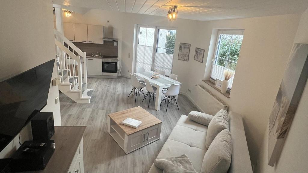 a living room with a couch and a table at LT35a Haus Sternengucker in Dorum-Neufeld