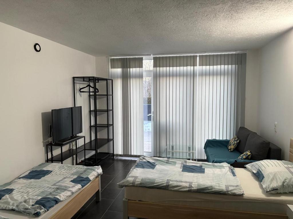 a bedroom with two beds and a flat screen tv at Apartmani Ela 1 in Sierning
