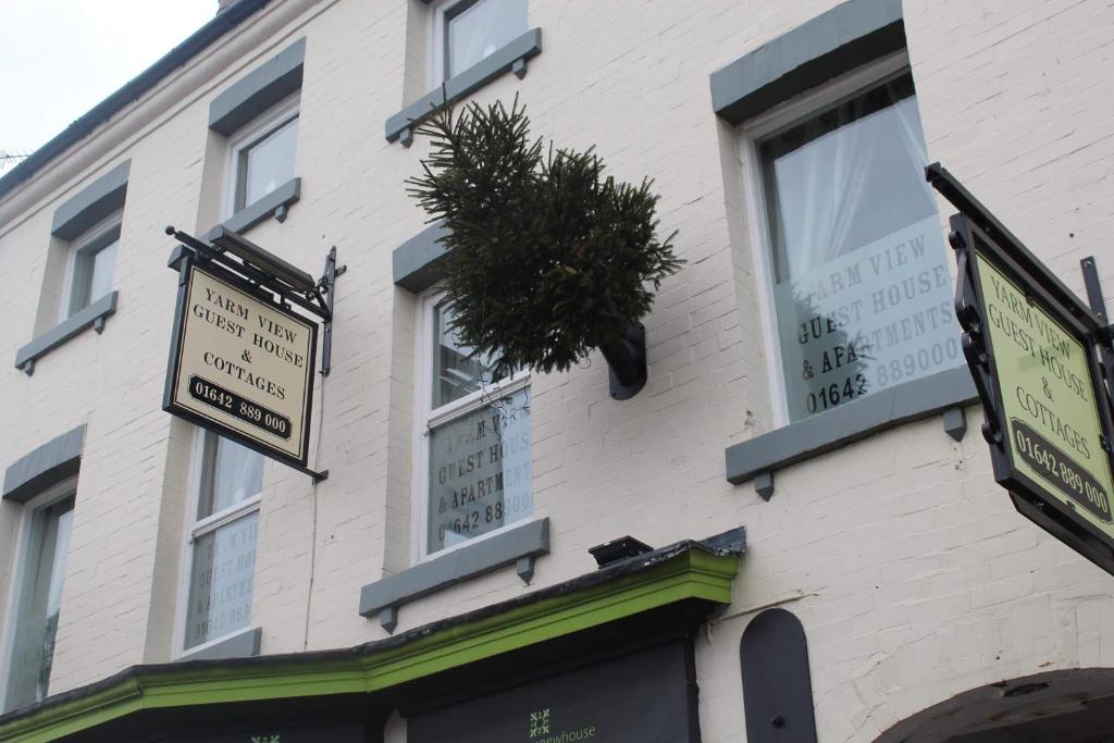 a building with signs on the side of it at Yarm View Guest House and Cottages in Yarm