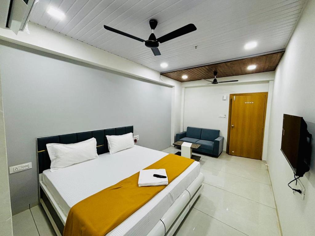 a bedroom with a bed and a ceiling fan at Hotel Hunter in Bārdoli