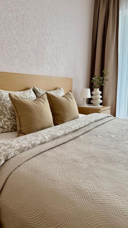 a bedroom with a large bed with pillows at Center two bedroom apartment in Daugavpils