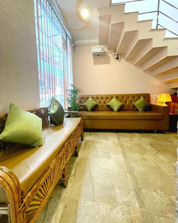 a living room with a couch and a window at Hotel Blue Moon in Rishīkesh