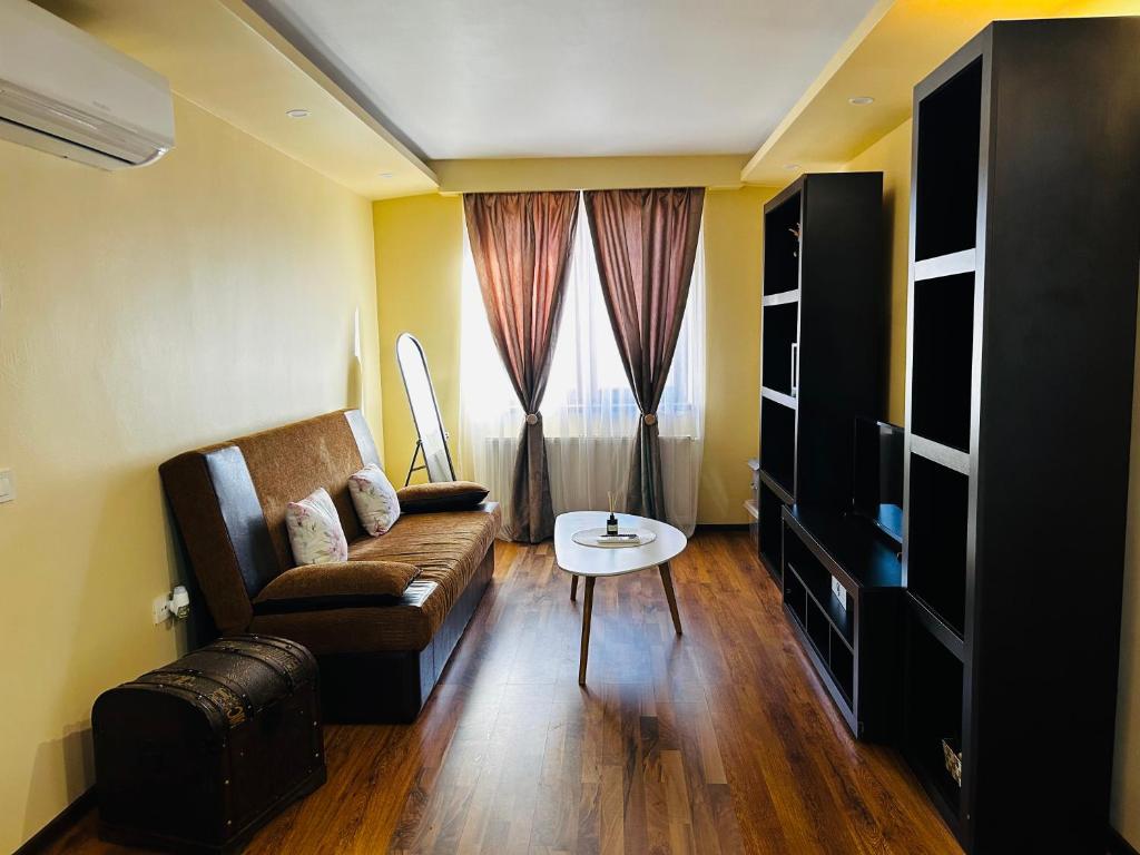 a living room with a couch and a table at IANIS Apartment in Orăştie