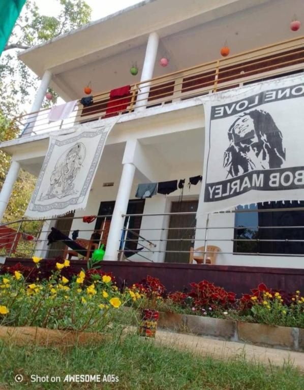 a building with a sign on the side of it at Mango tree room stay in Gokarna