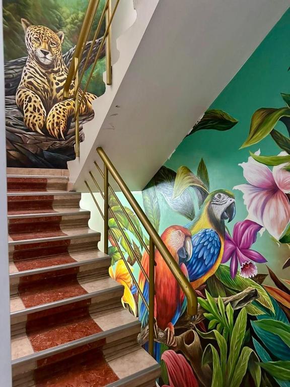 a staircase with a mural of a leopard and birds at Hospedaje El Imperio in Tarapoto