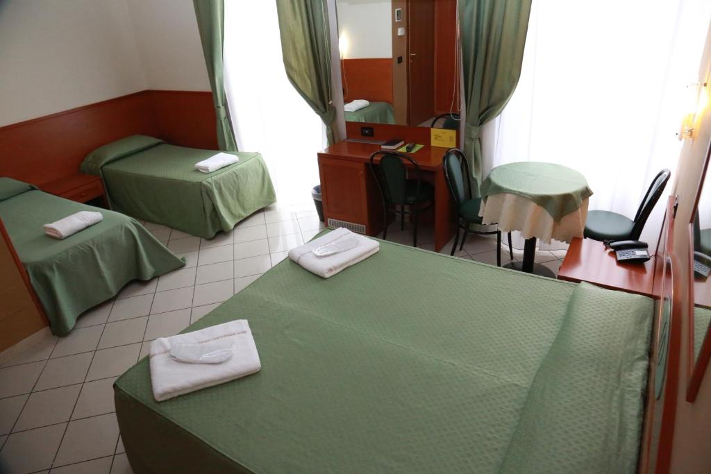 Posteľ alebo postele v izbe v ubytovaní Hotel Dorè