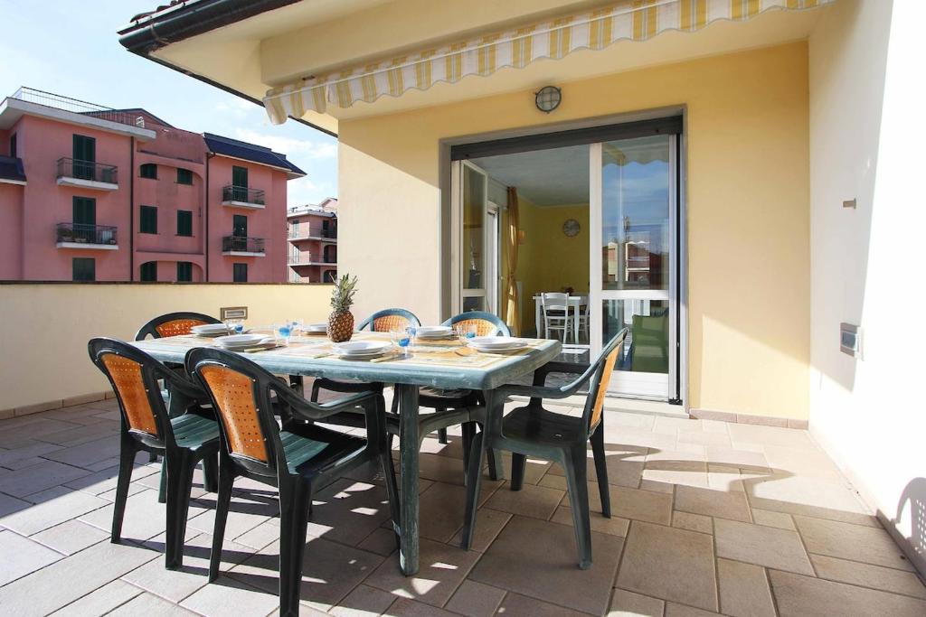 a table and chairs sitting on a patio at WI-RO Risorgimento,9 - La Perla di Andora in Marina di Andora