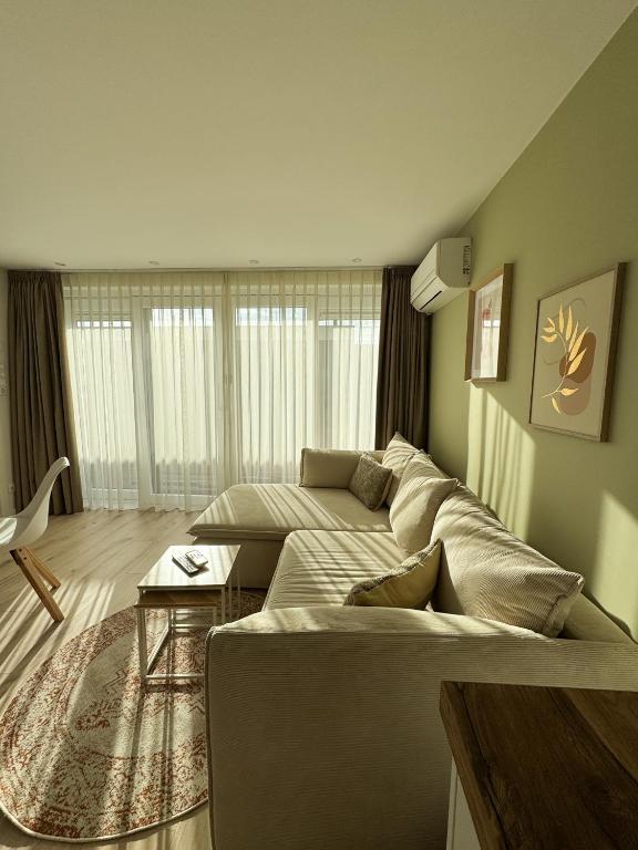 a living room with a couch and a table at Huisje Sille - Private studio in Volendam in Volendam