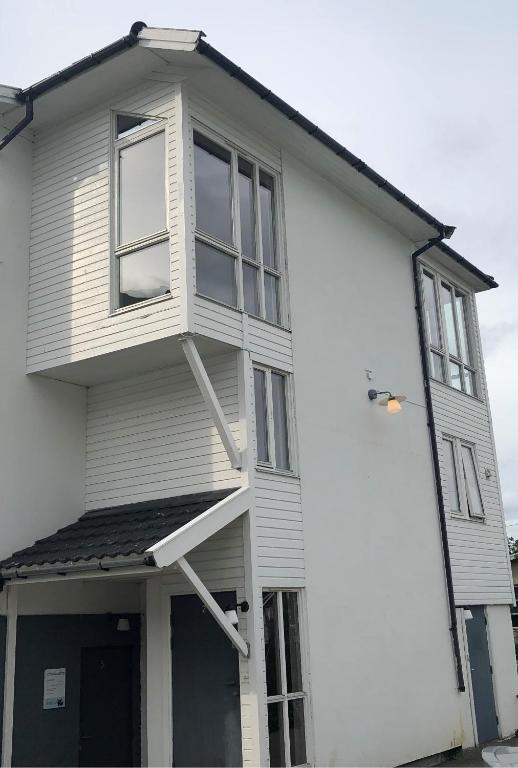 a white house with windows on the side of it at Tromsø Town and Nature 2 bedroom apt in Tromsø