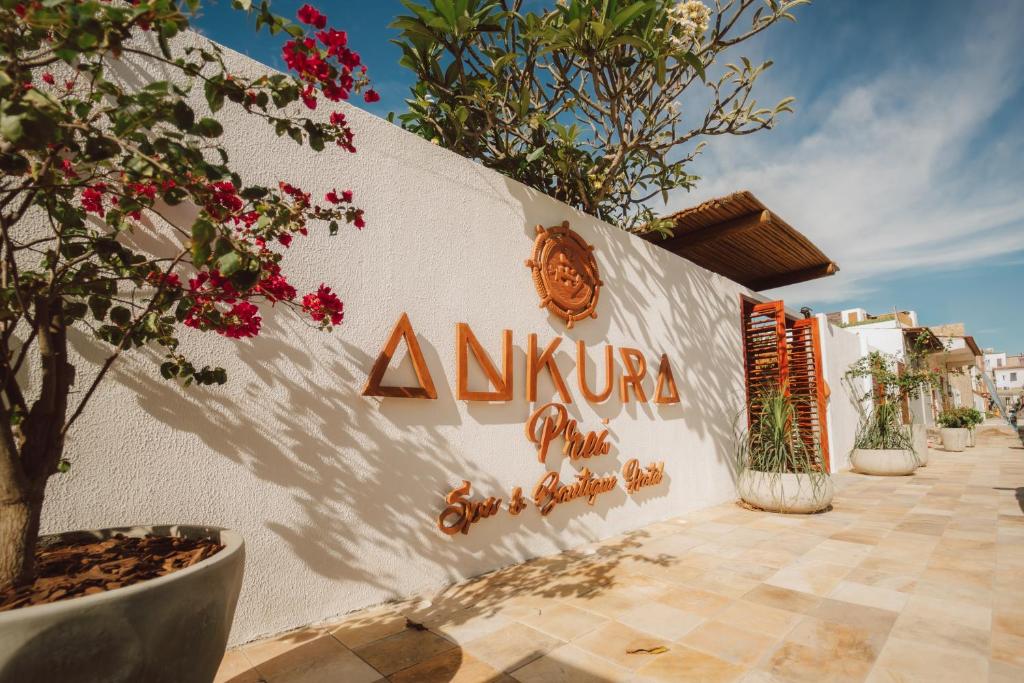 a white wall with aania sign on it at Ankura Preá Spa & Boutique Hotel in Cruz