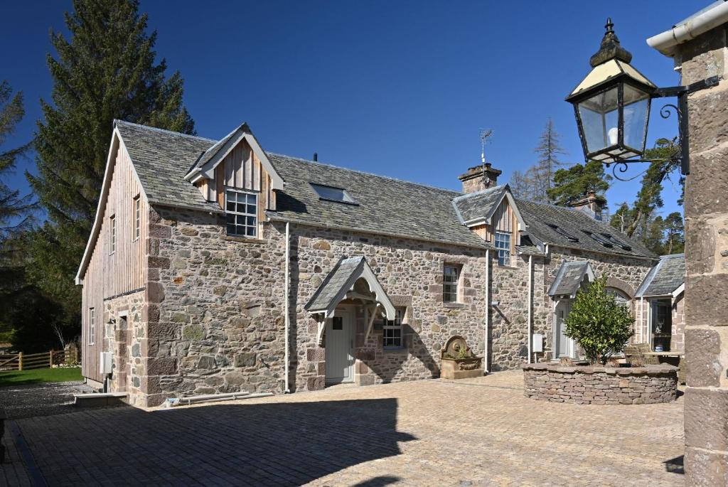 an old stone building with a street light at Kennels Cottage in Buchanty