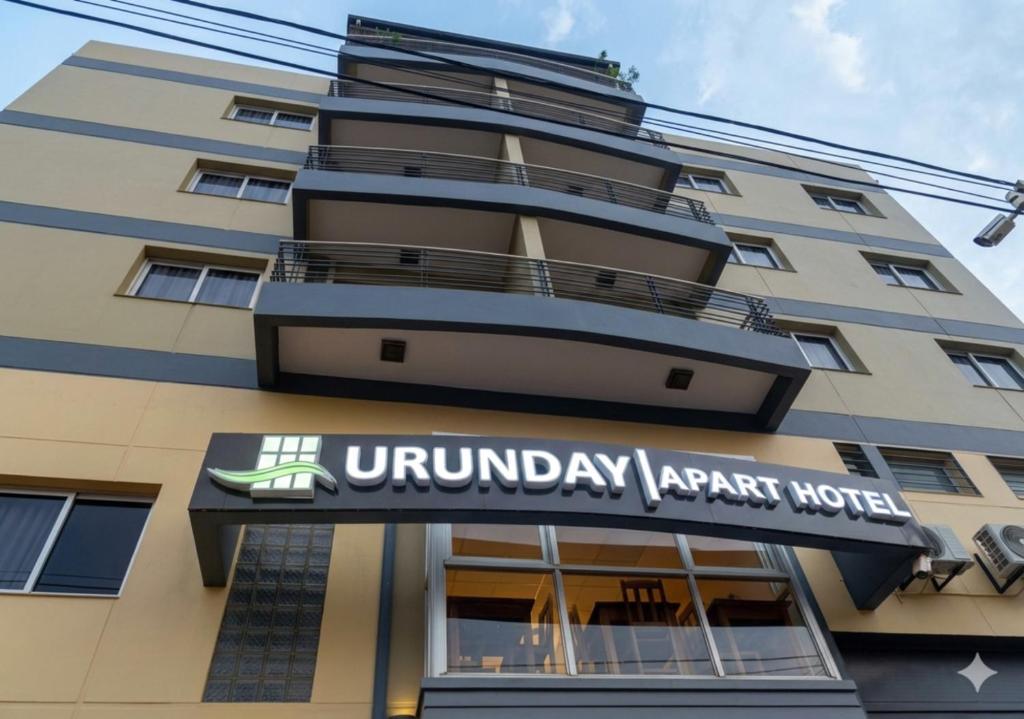 a building with a sign that readsuniversity apartment hotel at Urunday Apart Hotel in Posadas