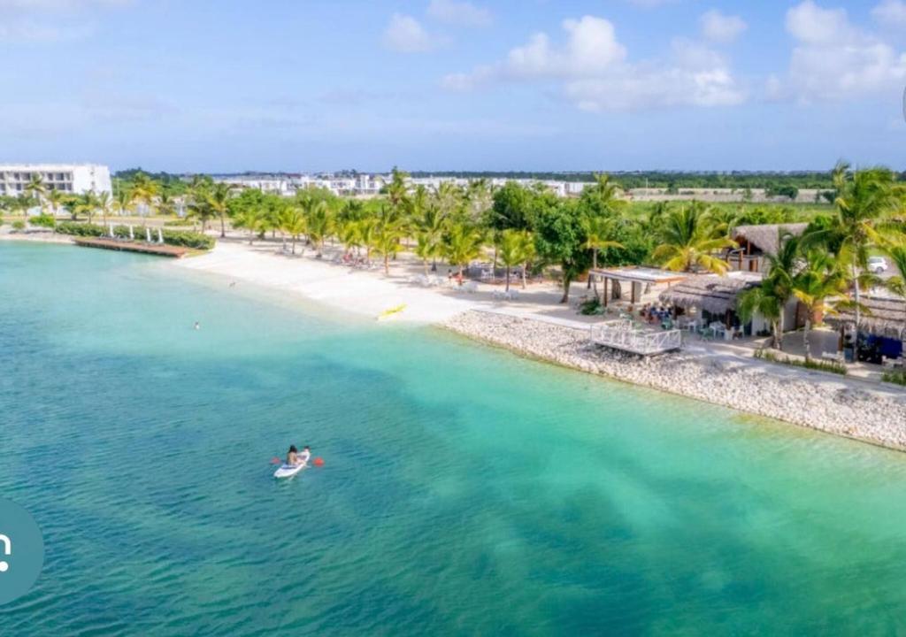 a person swimming in the ocean next to a beach at Damani Modern Pool Villa Escape in Punta Cana