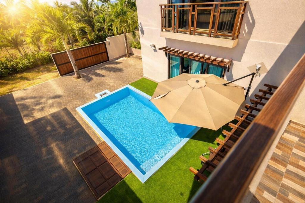an overhead view of a swimming pool with an umbrella at Hope Villa in Calodyne