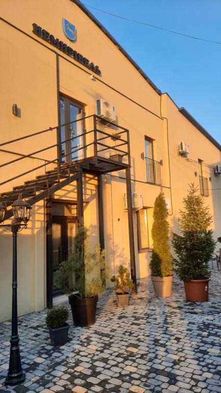 a building with a balcony and potted plants in front of it at Немирівель in Nemirov