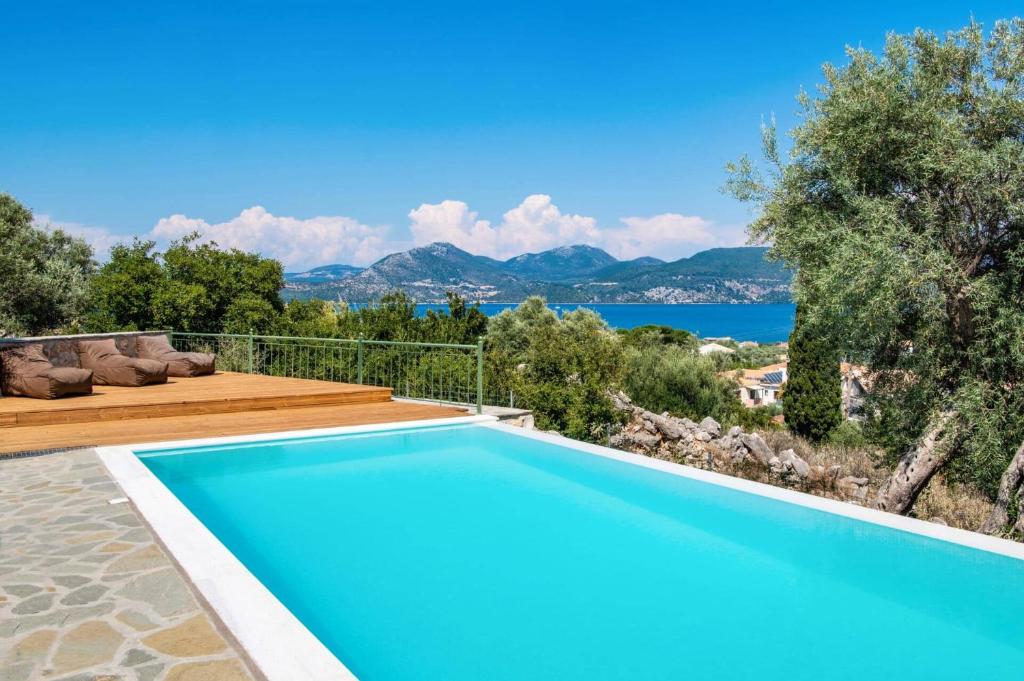 a swimming pool with a view of the water at Villa Loulou by Villa Plus in Nikiana
