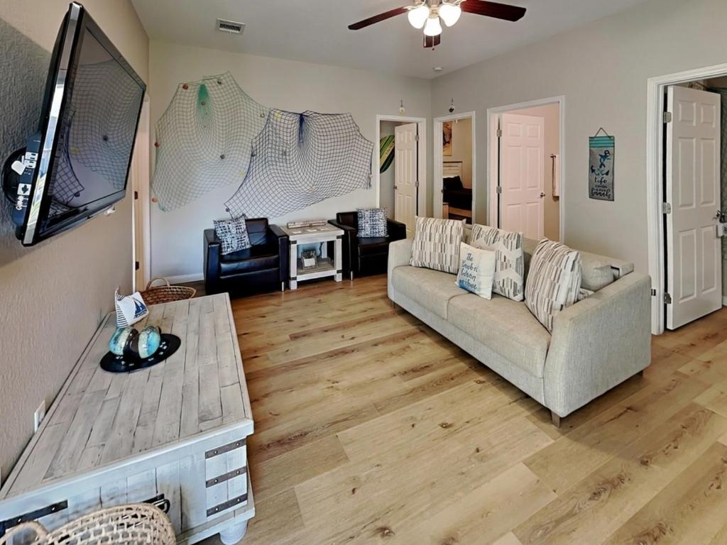 a living room with a couch and a table at Beach Ballin in Galveston