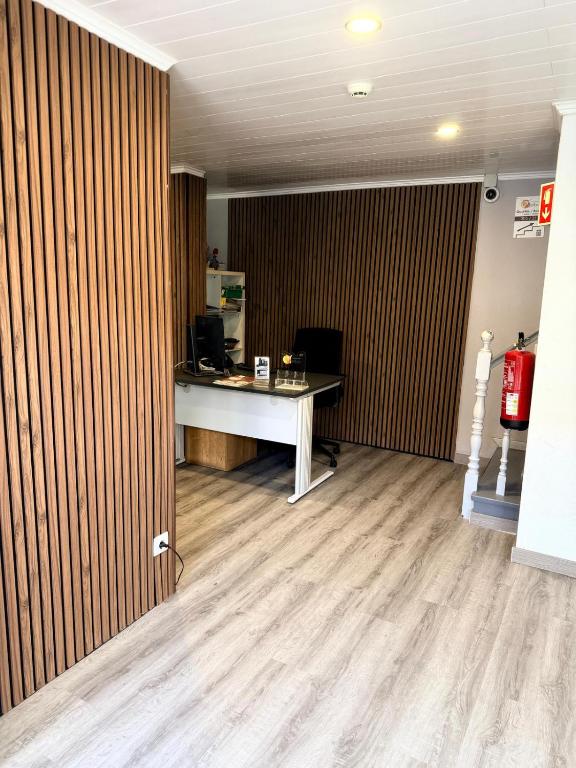 an office with a desk and a computer in a room at Residencial Melba in Funchal