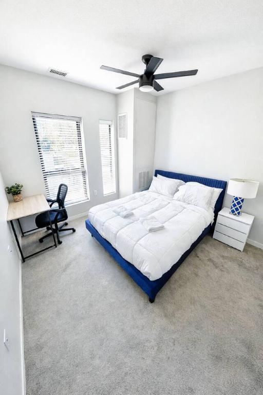 a bedroom with a bed and a ceiling fan at Cobalt Cove (132) in Des Moines
