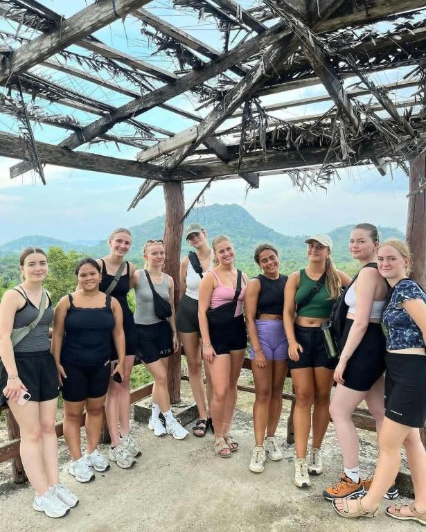 a group of people standing on top of a mountain at Riverston view hostel in Matale