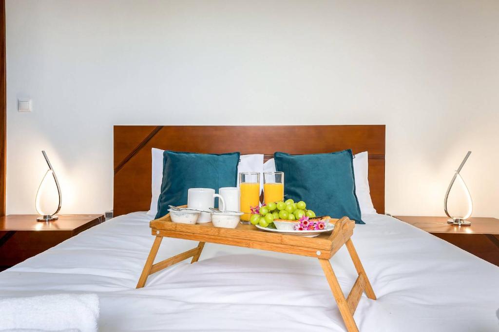 a tray of fruit and drinks on a bed at Villa Santana by GALMI in Santana
